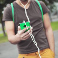 The inside scoop on music subscription services Man with phone and headphones