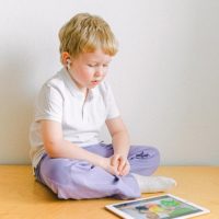 Netflix offers new parental control tools         boy-in-white-polo-shirt-sitting-iPad