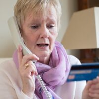 Help COVID-19 contact tracers, not scammers cropped OlderwomanonPhonewithCreditCard